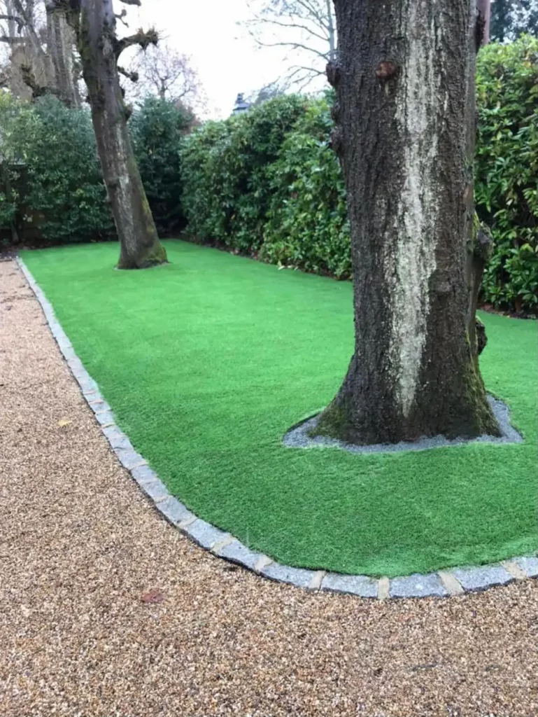 Artificial grass installed around trees
