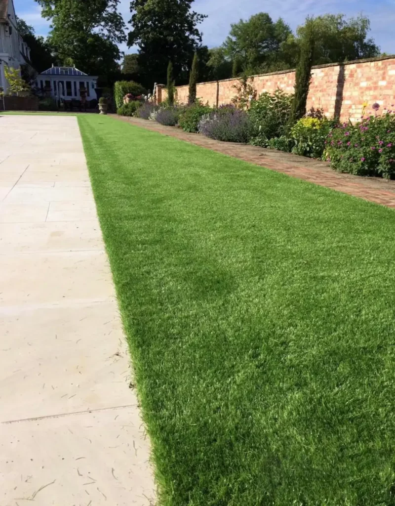 Artificial grass installation alongside patio