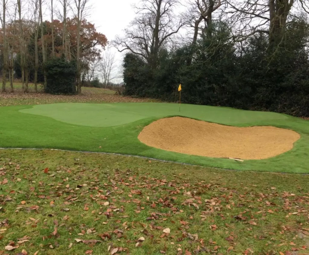 Artificial putting lawn with raised sand bunker