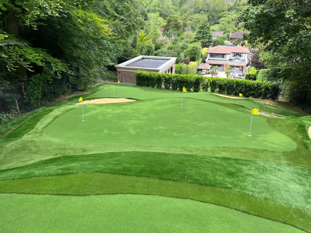 A residential putting green installation over multiple levels with artificial grass